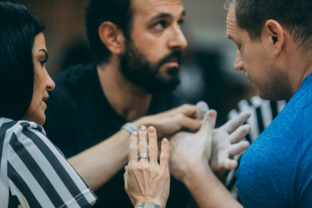 Close up of a group of young people putting their hands together.のeditorial素材