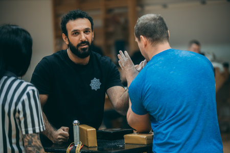 Portrait of a man with a beard and mustache talking to a friend during a break in a barbershopのeditorial素材