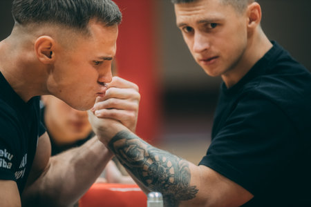 Tattooed male boxer training with his trainer in a gymのeditorial素材