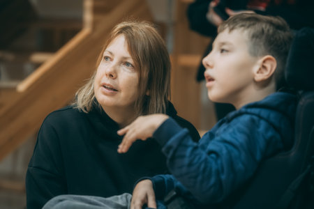 mother and son sitting on stairs looking at each other, family conceptのeditorial素材