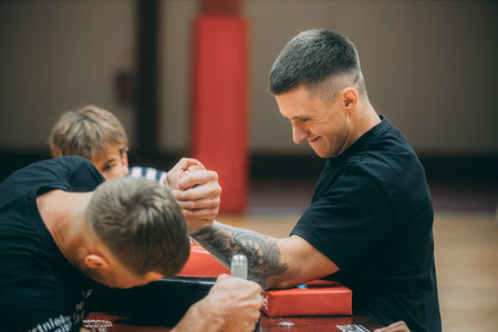 Male trainer helping senior man to make stretching exercises in the gym.のeditorial素材