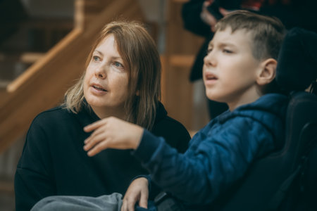 Mother and son sitting on stairs in the park and looking at each otherのeditorial素材