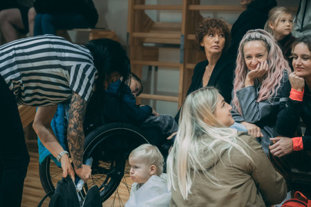 Young woman in wheelchair talking on mobile phone while waiting for a job interview.のeditorial素材