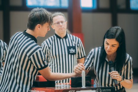Referee is showing the result of the game to his assistant.のeditorial素材