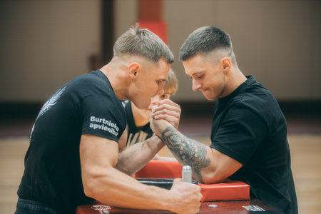 Personal trainer helping a young man in a gym. Selective focus.のeditorial素材