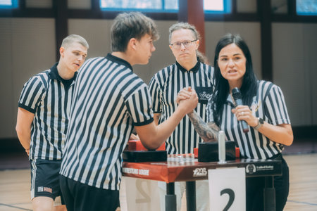 Unidentified female referee and her staff during a match in a basketball game.のeditorial素材