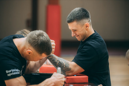 young man in a gym doing physical exercises with a personal trainer.のeditorial素材