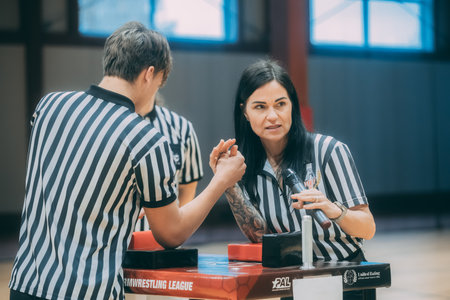 Referee giving instructions to a female referee in a sports hall.のeditorial素材