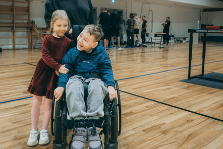 Little boy in a wheelchair with his friends in a dance studio.のeditorial素材