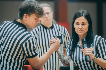 Referee in black and white uniform is talking to a female referee.のeditorial素材