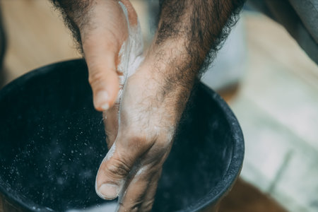 close up of a caucasian man washing his hands with a clothのeditorial素材