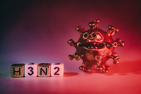 3D virus model with exaggerated features placed next to lettered blocks showing H3N2, highlighting themes of health, disease awareness, and scientific exploration in a vibrant atmosphereの写真素材