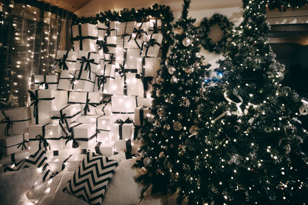 Holiday setting showcases an arrangement of wrapped gifts with black ribbons, surrounded by...