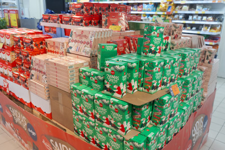 Valmier, Latvia - November 24, 2025: Festive arrangement of holiday snacks in supermarket, featuring colorful packaging and Christmas-themed designs for seasonal shoppingのeditorial素材