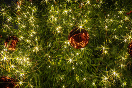 Festive Christmas tree decorated with sparkling lights and golden ornaments, radiating warmth and joy, creating a magical holiday ambianceの写真素材
