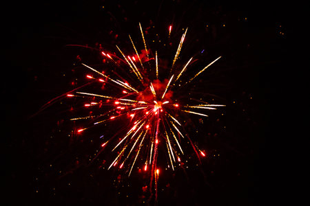 Colorful fireworks illuminate the dark sky, creating stunning visual effects and patterns, enhancing...