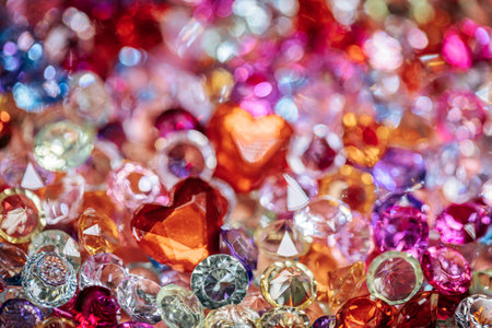 Assorted sparkling gemstones and crystals in various colors and shapes, including heart shapes, creating a vibrant and decorative display for crafts or jewelryの写真素材