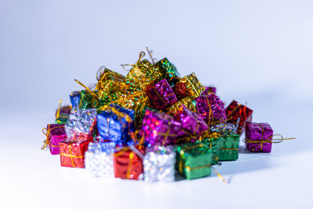 A collection of vibrant gift boxes in different colors and sizes, arranged together on a white...