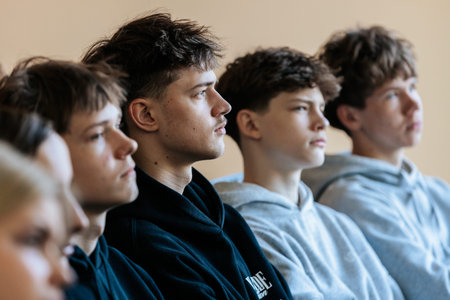 Valmiera, Latvia - March 17, 2026: Young males with different hairstyles focus on a presentation in...