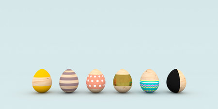 Wooden colorful patterned Easter egg light blue backgroundの写真素材