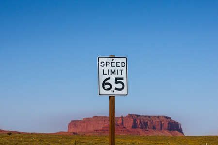 Speed Limit 65 - Sign with Monument Valley butte in background. US american road signの写真素材
