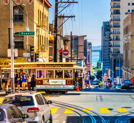 SAN FRANCISCO - September 22, 2015: Cable car in the heart of San Francisco with many tourists on a colorful summer day. Cable Car of Powell-Hyde-Line at the junction of Powell Washington Street.のeditorial素材
