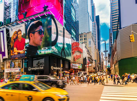 New York City - June 14, 2017: Broadway with street traffic and crowded by many people. The scenery at Times Square in NYC is an iconic landmark famous for tourists as world's busiest pedestrian placeのeditorial素材