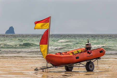 Rigid inflatable boat (Rib) on the beach ready for quick launch by lifeguards watching over the surfers and swimmers in the ocean.の写真素材