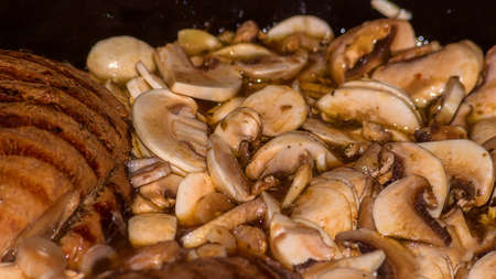 Close-up of roast pork with sliced ​​mushrooms.の写真素材
