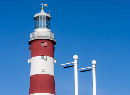 Red and white lighthouse Smeaton\'s Tower standing on a background of blue sky on Hoe in the English Plymouth.のeditorial素材