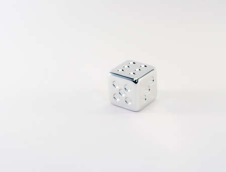 Silver dice on a white backgroundの写真素材