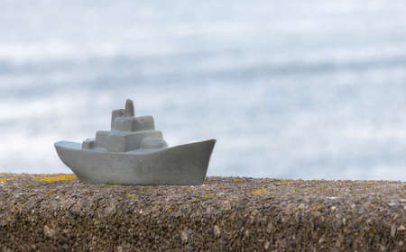 Model of warship standing on a wall in Plymouth.