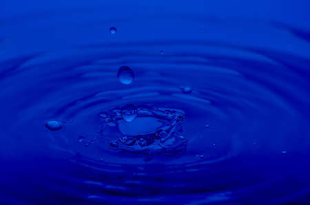 Water drops close up in blue color.の写真素材