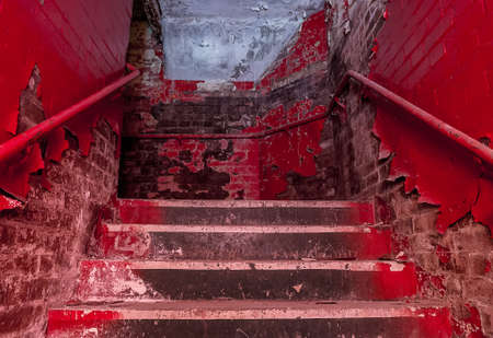 Destroyed staircase with emergency exit in an old building.の写真素材