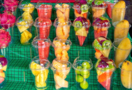 Fresh fruit and vegetables prepared for making fruit cocktails for sale at the Bangkok market.の写真素材