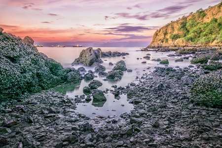 Sea sunrise with mountain stoneの写真素材