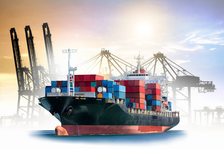 Logistics and transportation of International Container Cargo ship with ports crane bridge in harbor for logistic import export background and transport industry.の写真素材