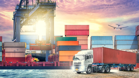 Logistics import export background and transport industry of Container Cargo ship and Cargo plane with working crane bridge in shipyard at sunset skyの写真素材
