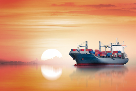International Container Cargo ship in the ocean as sunset sky, Freight Transportation, Shippingの写真素材
