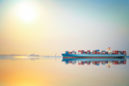 International Container Cargo ship in the ocean as sunset sky, Freight Transportation, Shippingの写真素材