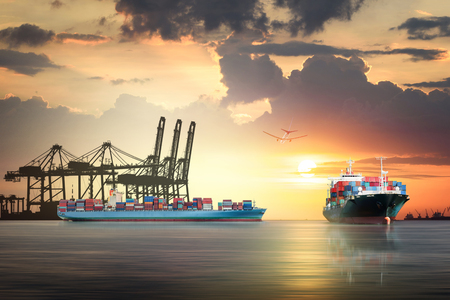 Logistics and transportation of international container cargo ship and cargo plane with port crane bridge in harbor at sunset sky, Freight Transportation, Shippingの写真素材