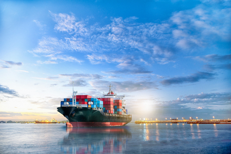 Logistics and transportation of International Container Cargo ship in the ocean at twilight sky, Freight Transportation, Shippingの写真素材