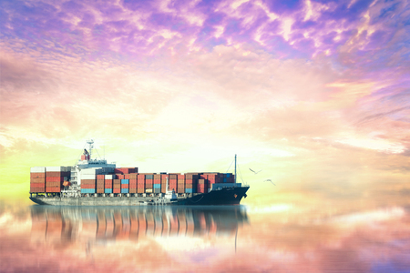 Container Cargo ship in the ocean at sunset sky, Freight Transportation, Shippingの写真素材