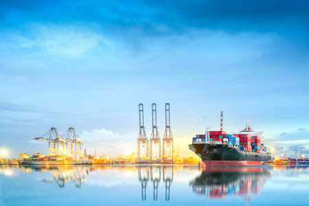 Logistics and transportation of International Container Cargo ship in a harbor with water reflections for logistic import export background and transport industry.の写真素材