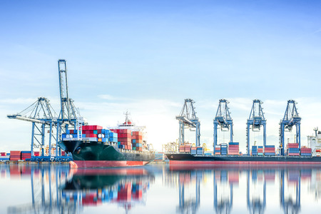 International Container Cargo ship with working crane bridge in shipyard background, logistic import export background and transport industry.の写真素材