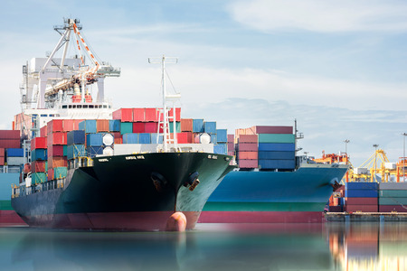 International Container Cargo ship with working crane bridge in shipyard background, logistic import export background and transport industry.の写真素材
