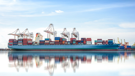 International Container Cargo ship with working crane bridge in shipyard background, logistic import export background and transport industry.の写真素材