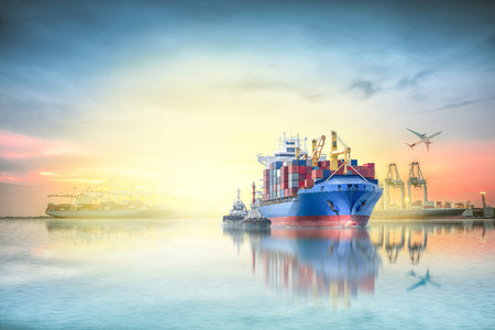 Logistics and transportation of international container cargo ship and cargo plane with ports crane bridge in harbor at sunset sky for logistics import export background and transportation industry.の写真素材