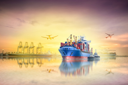 Logistics and transportation of international container cargo ship and cargo plane with ports crane bridge in harbor at sunset sky for logistics import export background and transportation industry.の写真素材