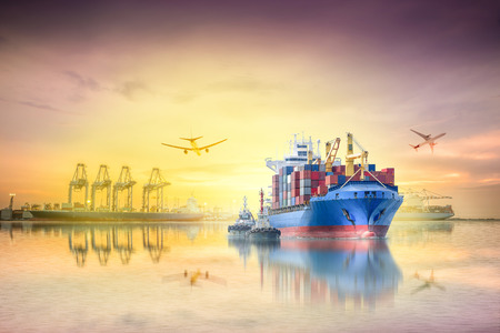 Logistics and transportation of international container cargo ship and cargo plane with ports crane bridge in harbor at sunset sky for logistics import export background and transportation industry.の写真素材